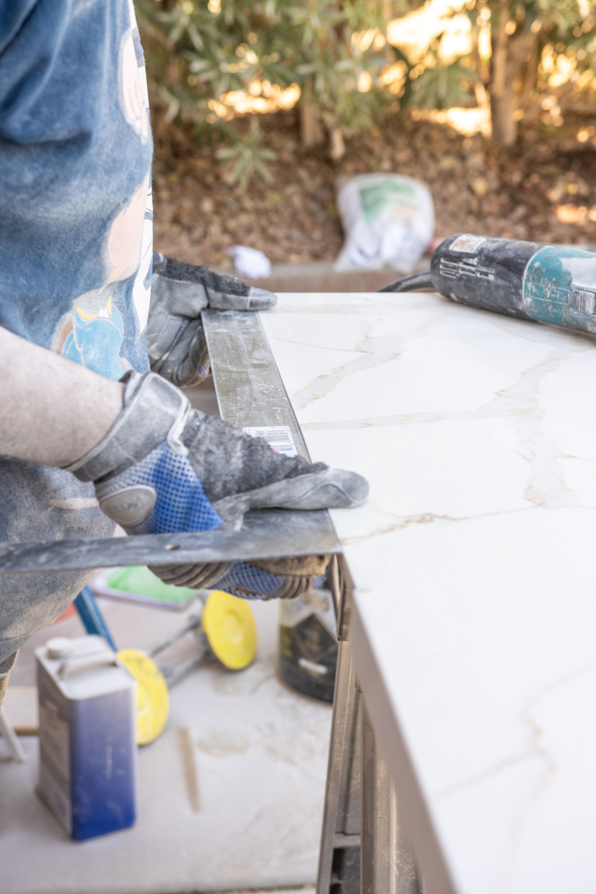 Carrillo Innovations team measuring stone countertops during a commercial installation project