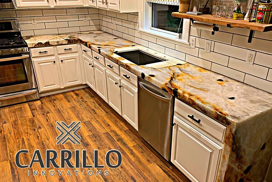 A kitchen with stainless steel appliances and granite counter tops.