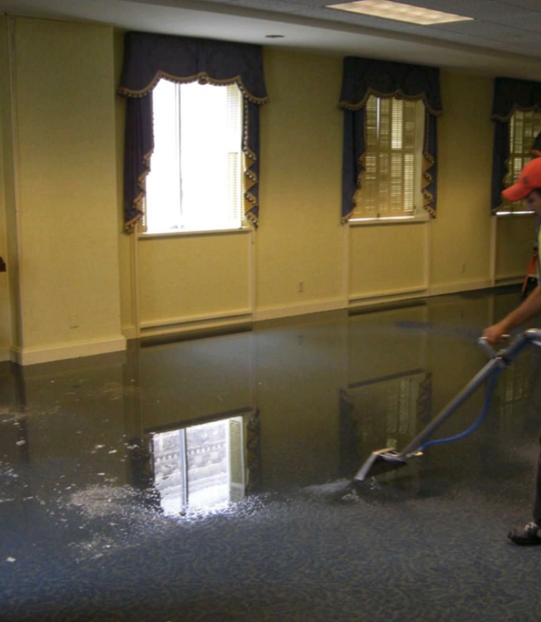 The back of a van filled with stacks of blue and gray containers.
