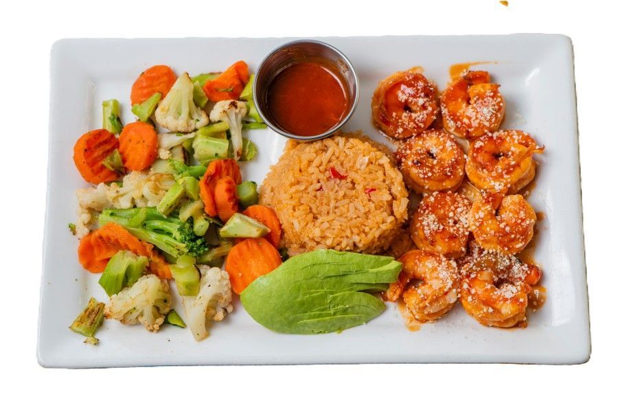 Two people grate cheese onto a pizza, kitchen setting.