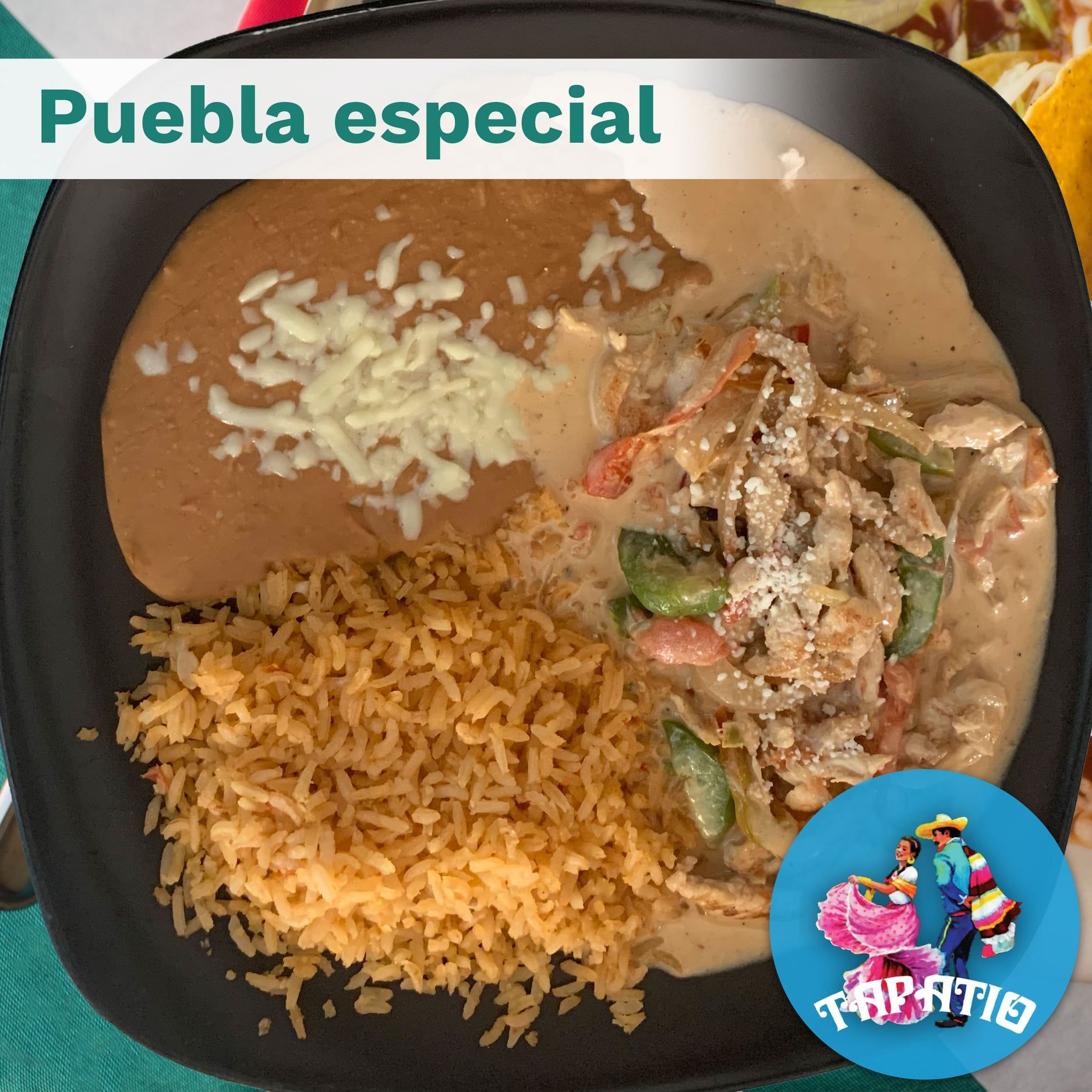 Puebla especial: Plate with rice, beans, meat in sauce, and cheese.