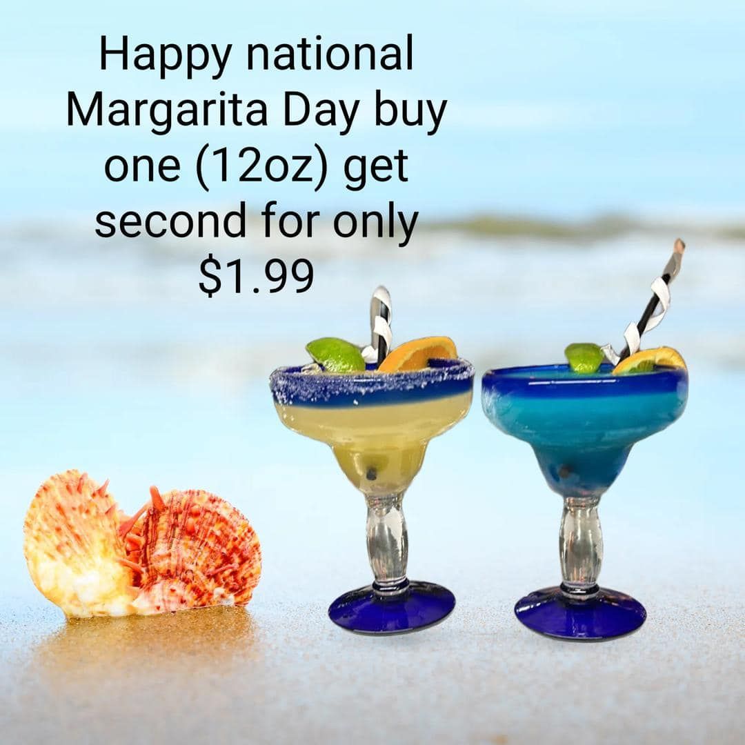Two margarita drinks with a special offer on a beach