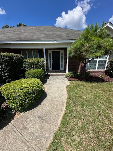 A house with a walkway leading to the front door