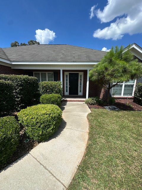 A house with a walkway leading to the front door