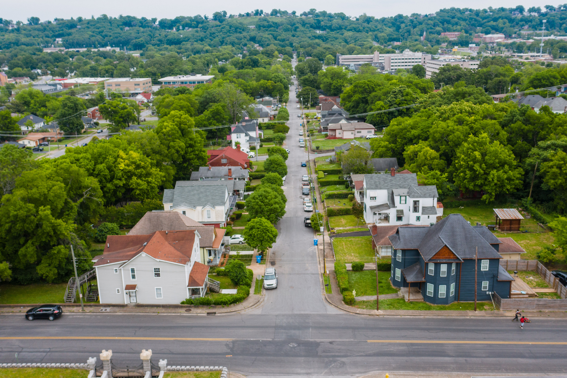 An aerial view of a residential neighborhood with lots of trees and houses.