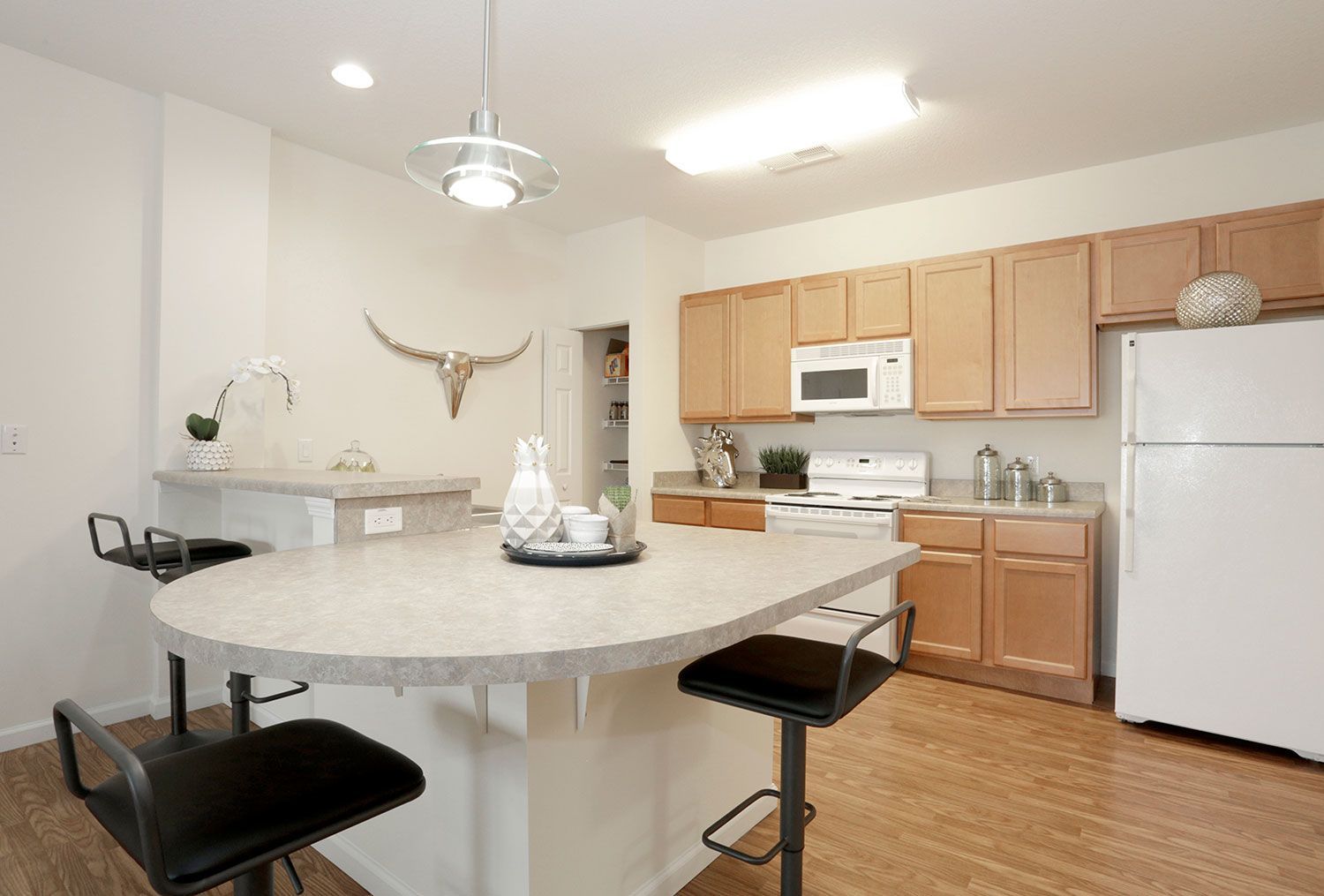 a kitchen with brown cabinets and a white refrigerator