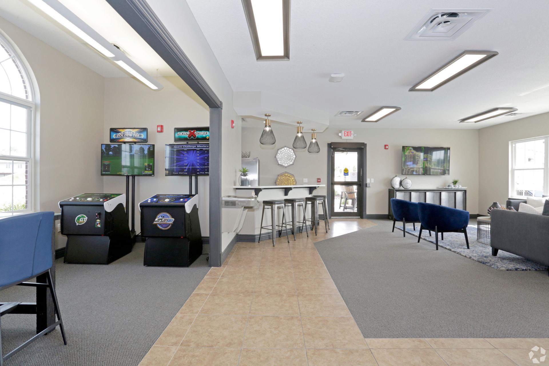 a room with a few arcade games and a tv