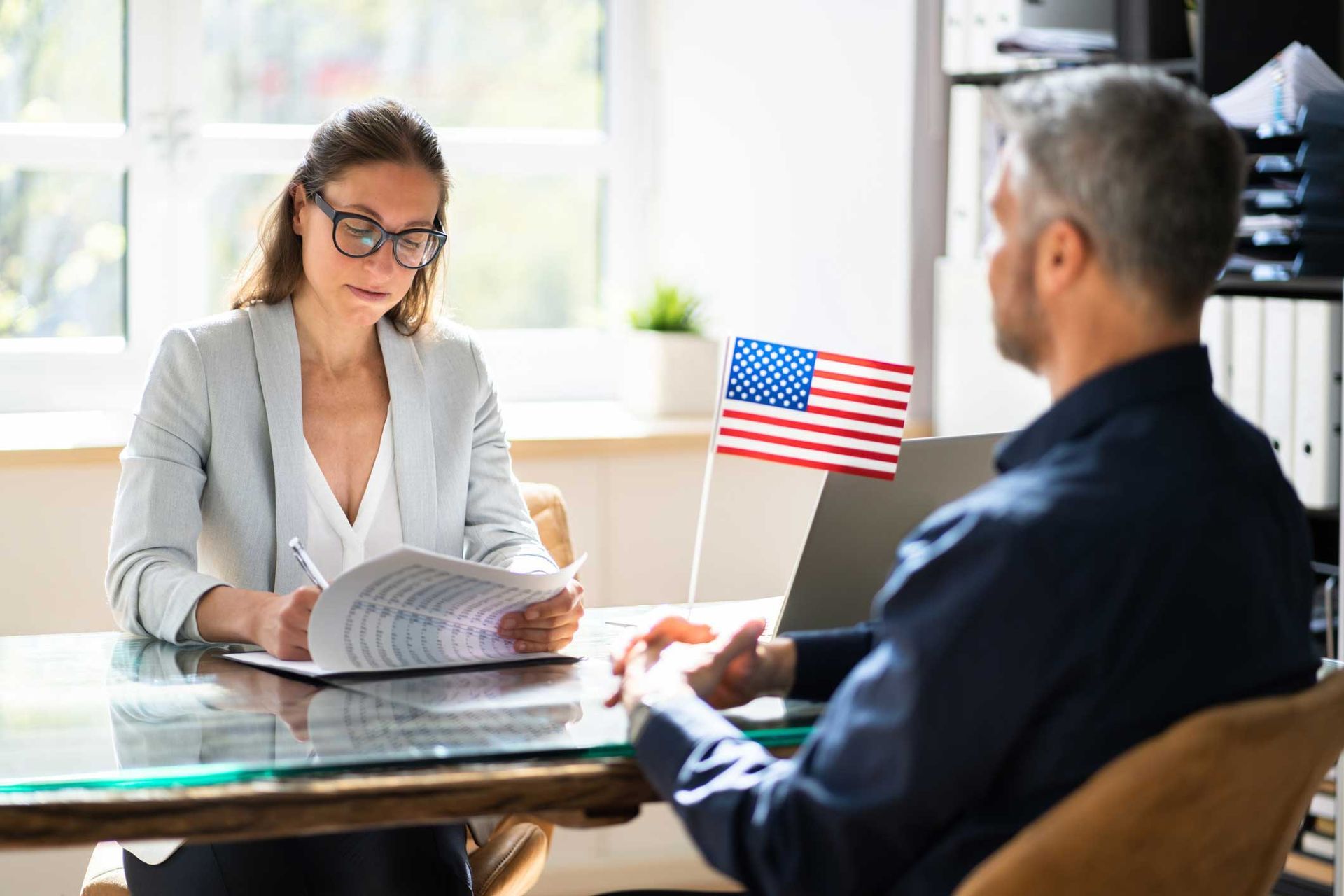 A man and a woman are sitting at a table having a job interview.