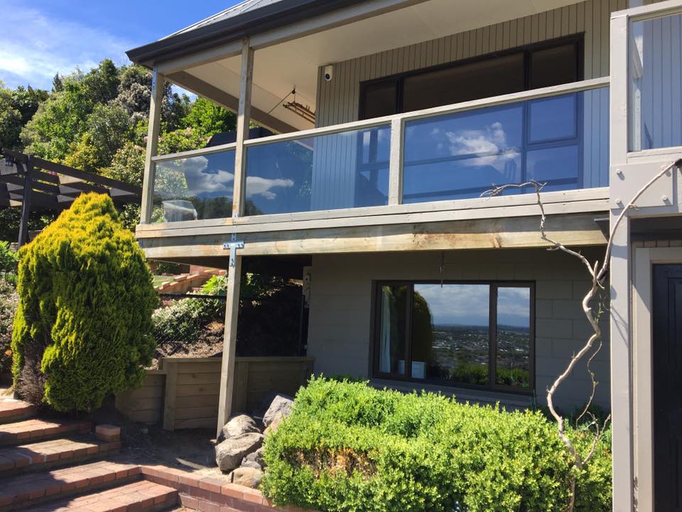 A house with a balcony and stairs leading up to it.