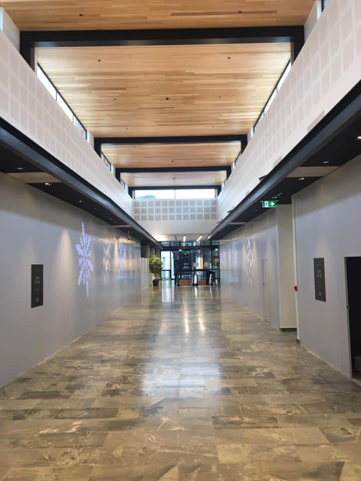 A long hallway in a building with a wooden ceiling