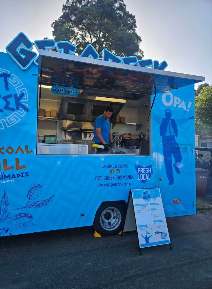 A blue food truck with the word opa on it