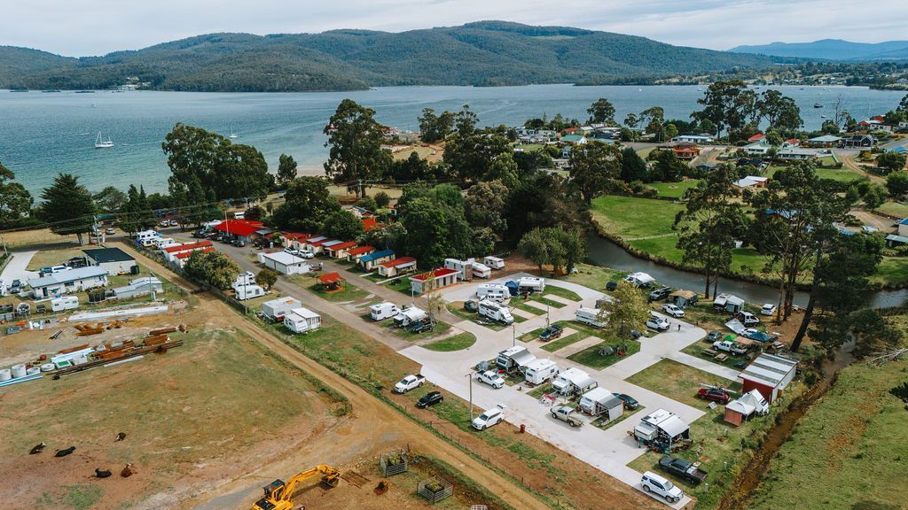 An aerial view of a campground with a lake in the background.