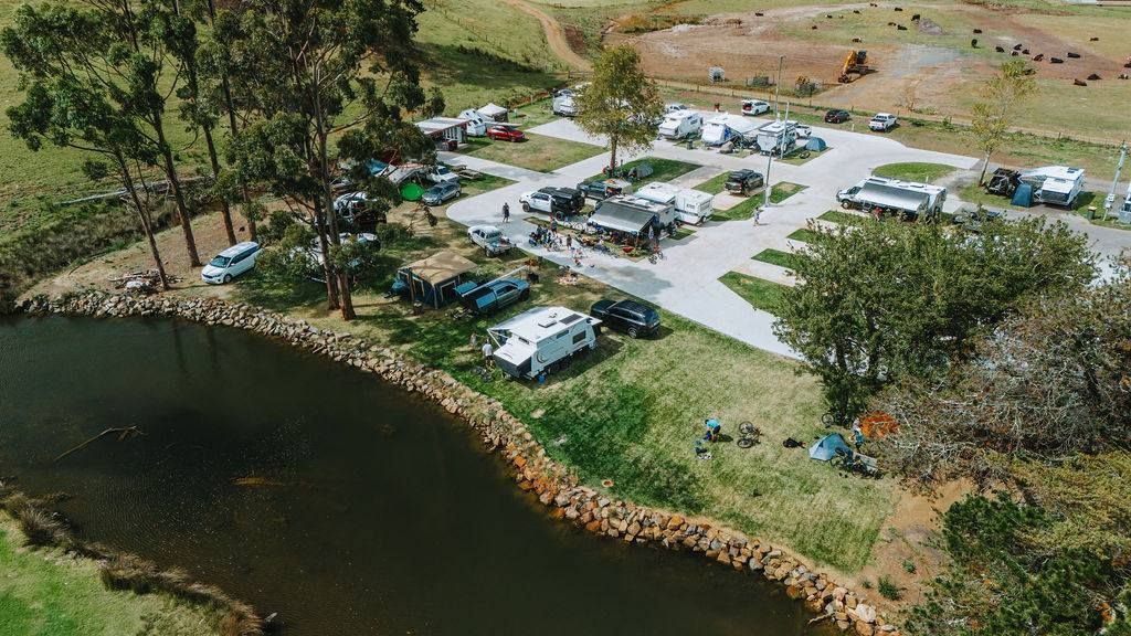 An aerial view of a campground with a lake in the middle.