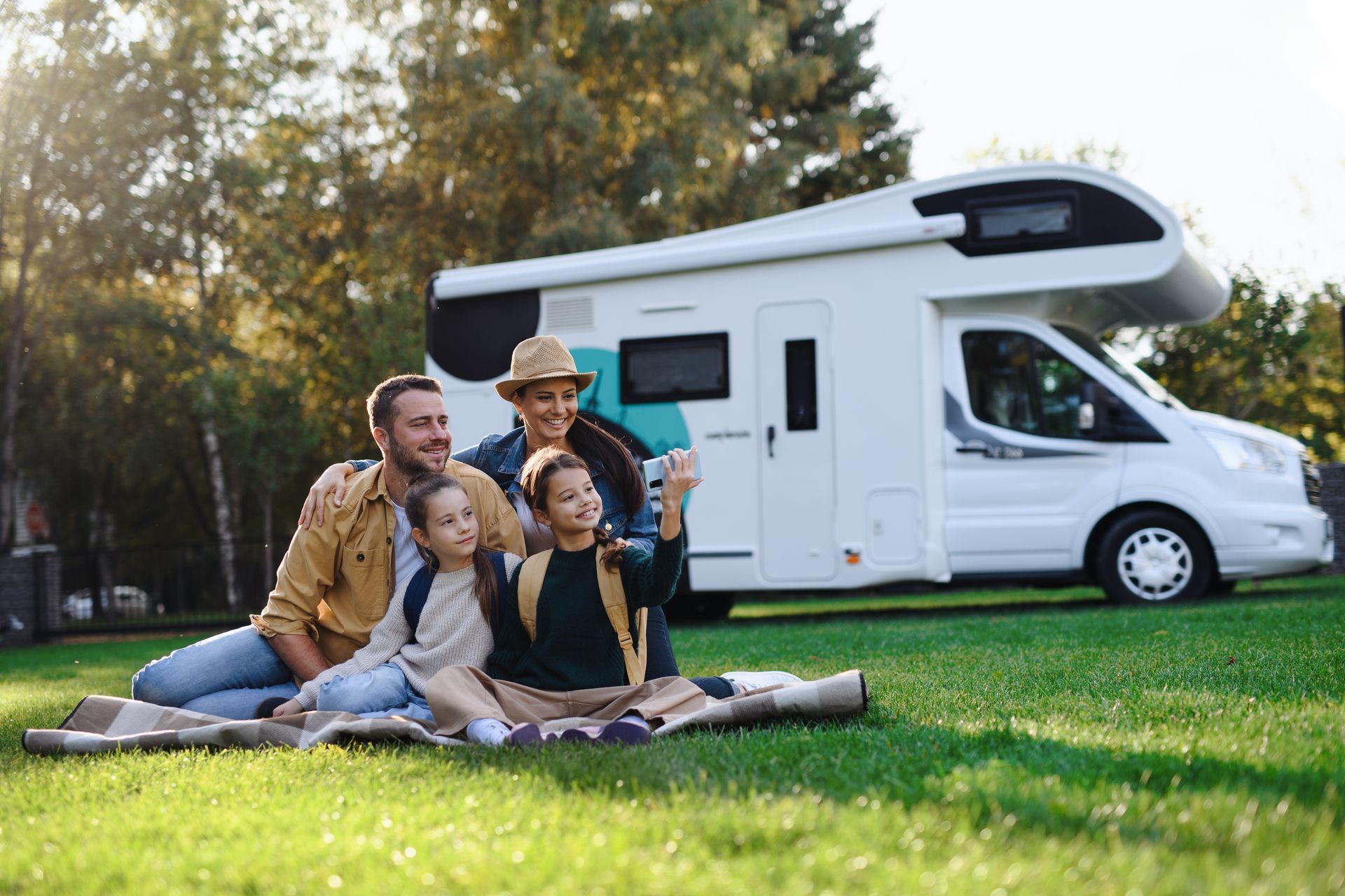 A family taking a selfie with a caravan in the background, highlighting caravan park accommodation. A family taking a selfie with a caravan in the background, highlighting caravan park accommodation.