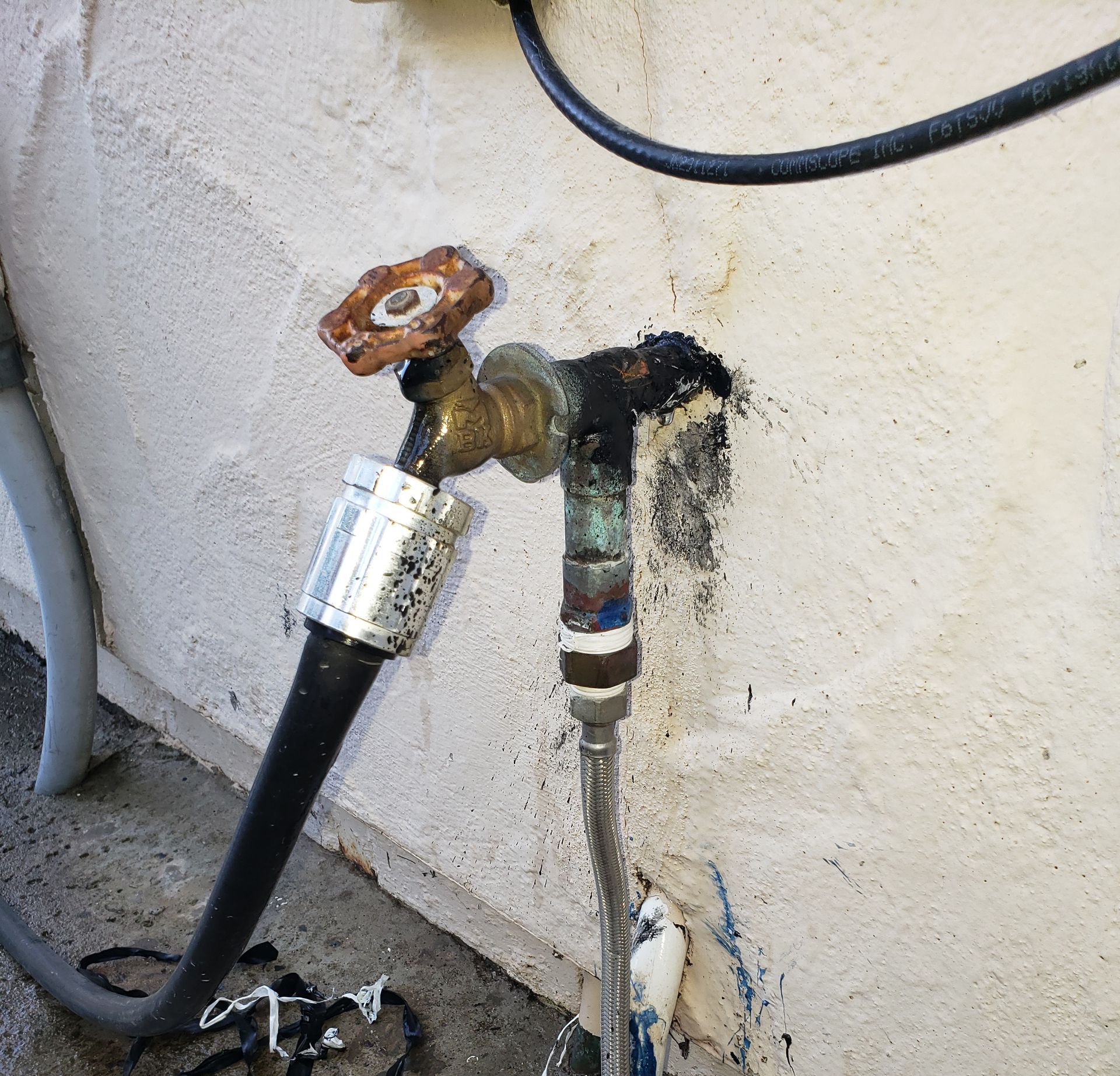 A hose is attached to a faucet on a wall