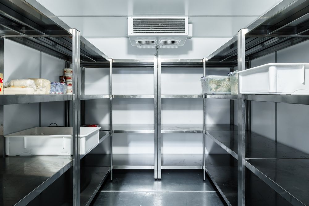 An Empty Refrigerator With Stainless Steel Shelves in a Kitchen — Gympie Air-Conditioning & Refrigeration In Southside, QLD