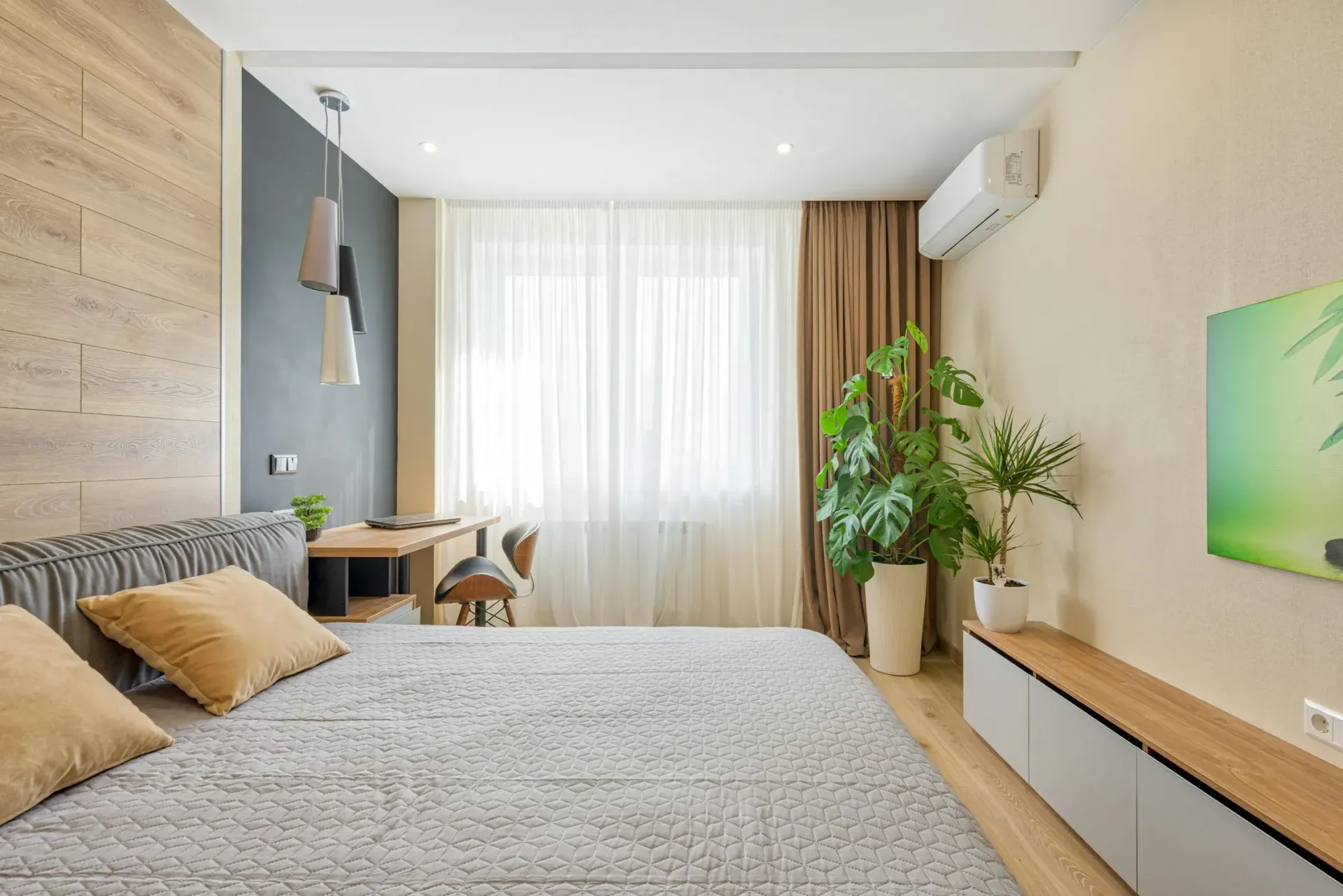A Man is Working on an Air Conditioner With a Screwdriver — Gympie Air-Conditioning & Refrigeration In Southside, QLD