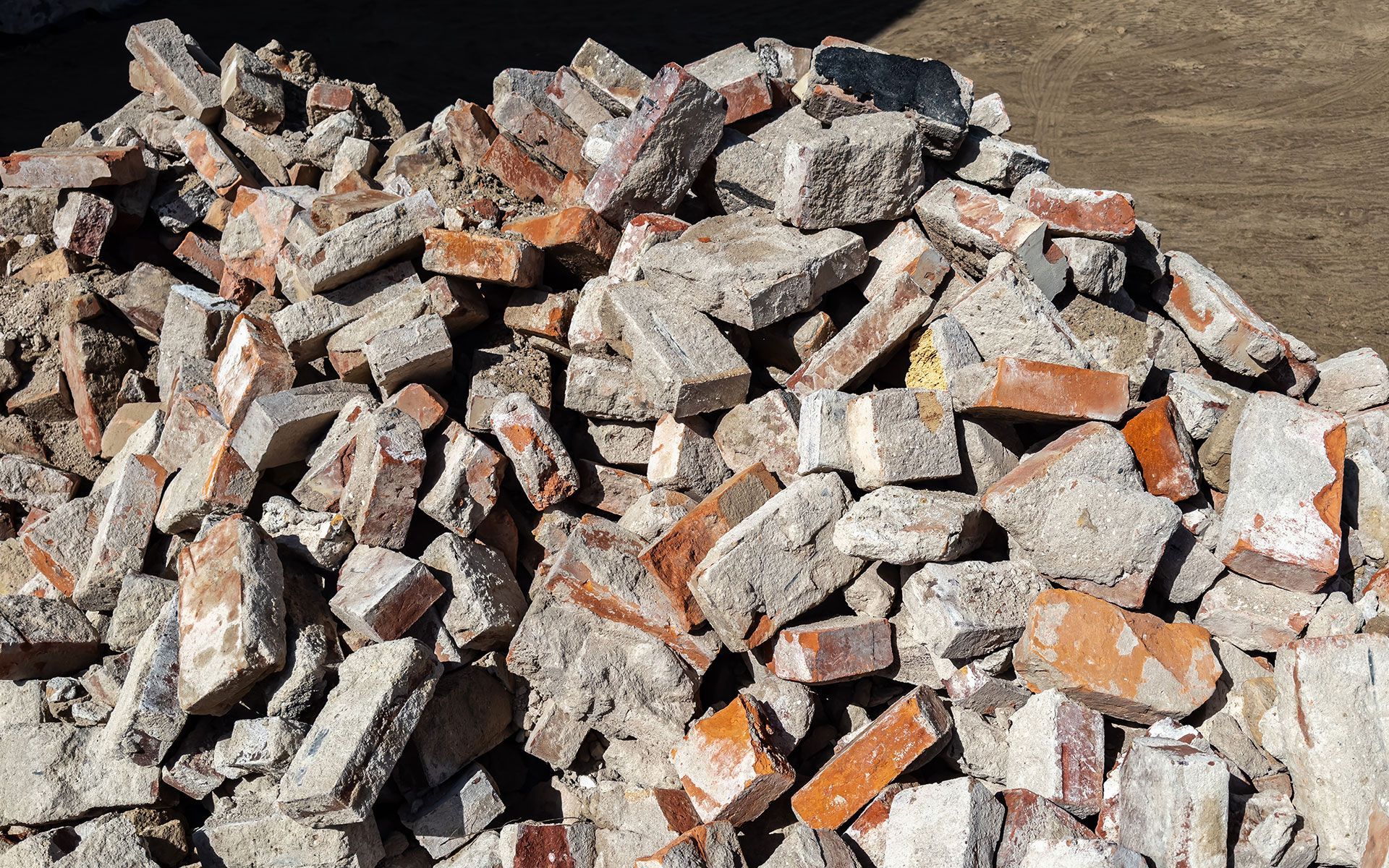 Pile of broken bricks and rubble at a construction site.