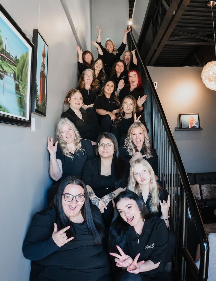 A group of women are posing for a picture on a set of stairs.
