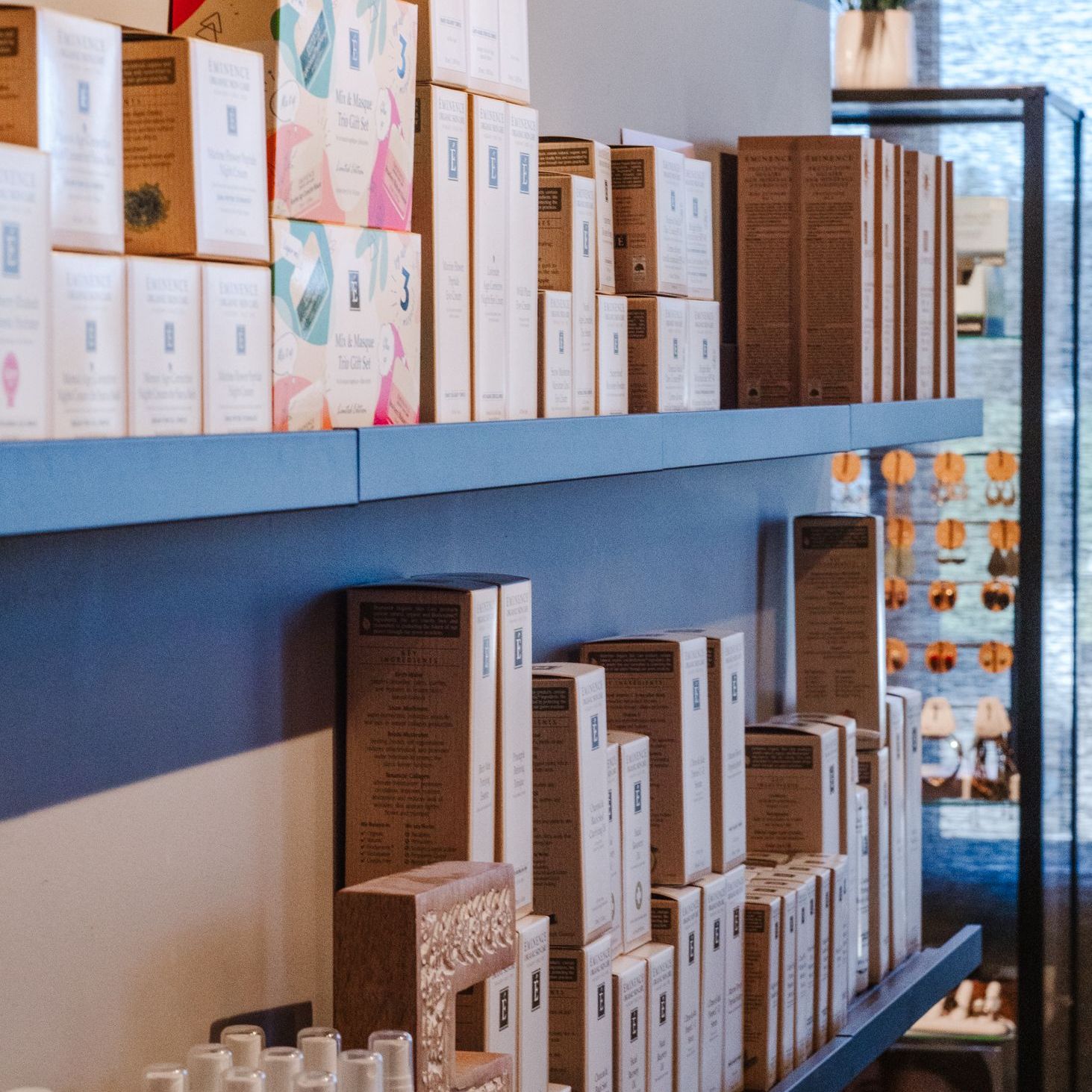 A shelf full of boxes and bottles including one that says ' a ' on it