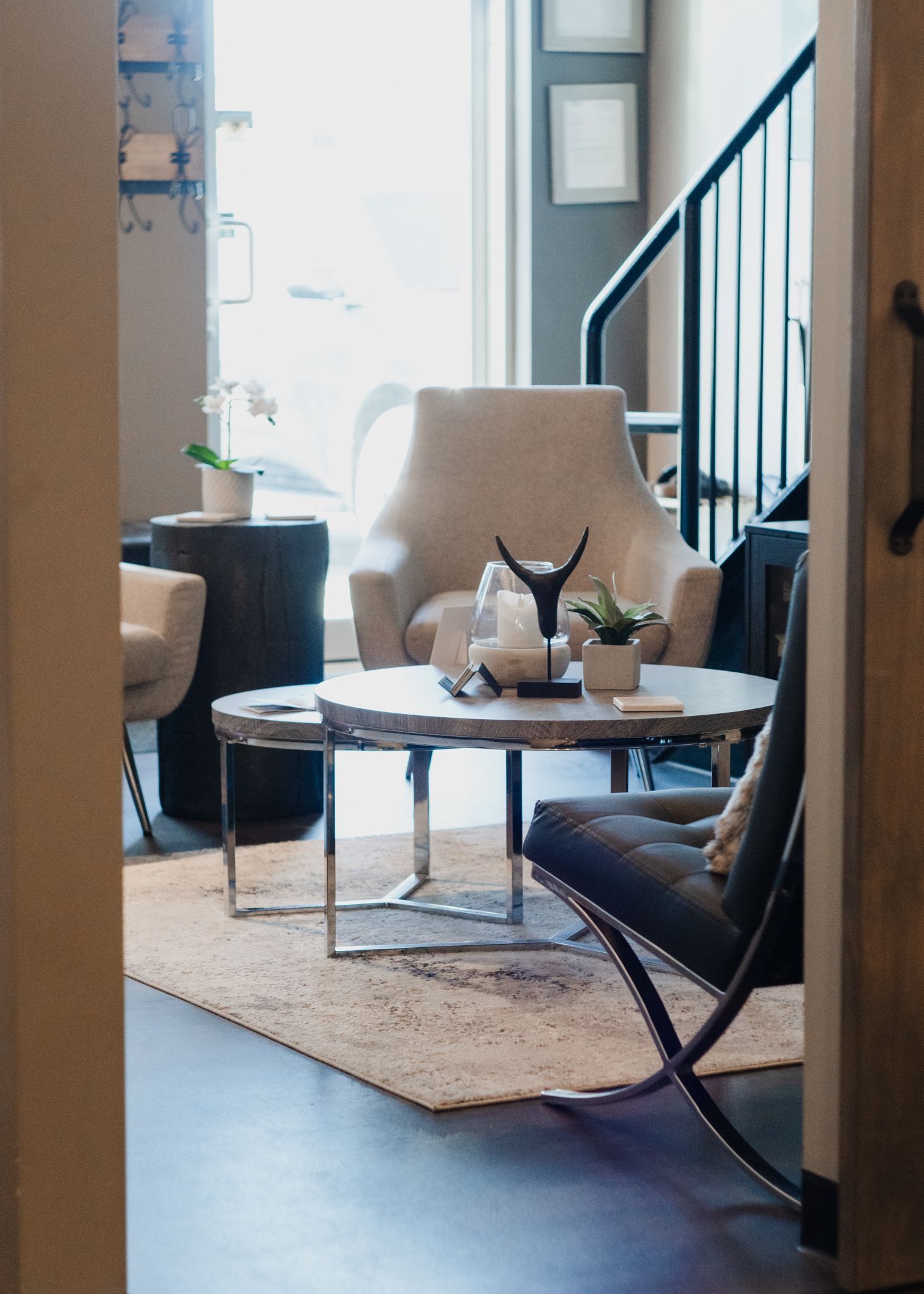 A living room with a table chairs and stairs