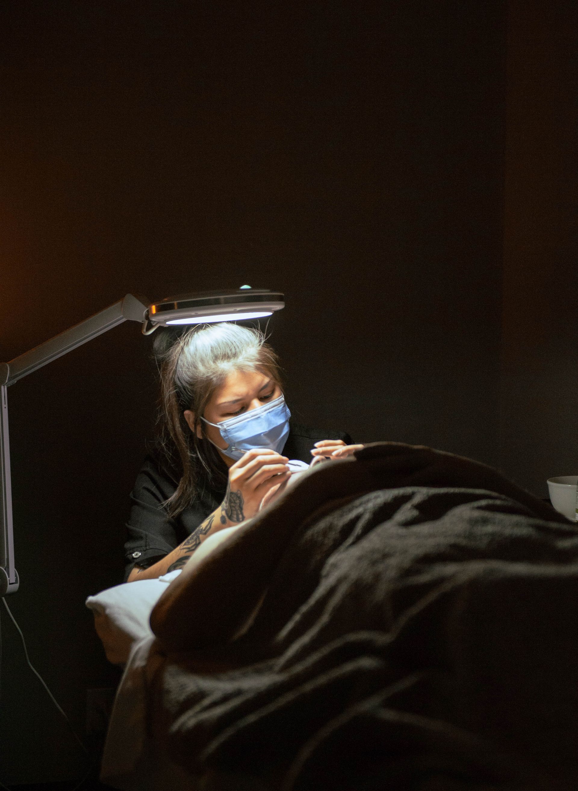 A woman is getting a facial treatment at a spa.