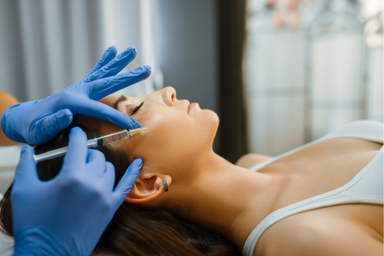 A woman is getting her eyelashes done at a beauty salon.