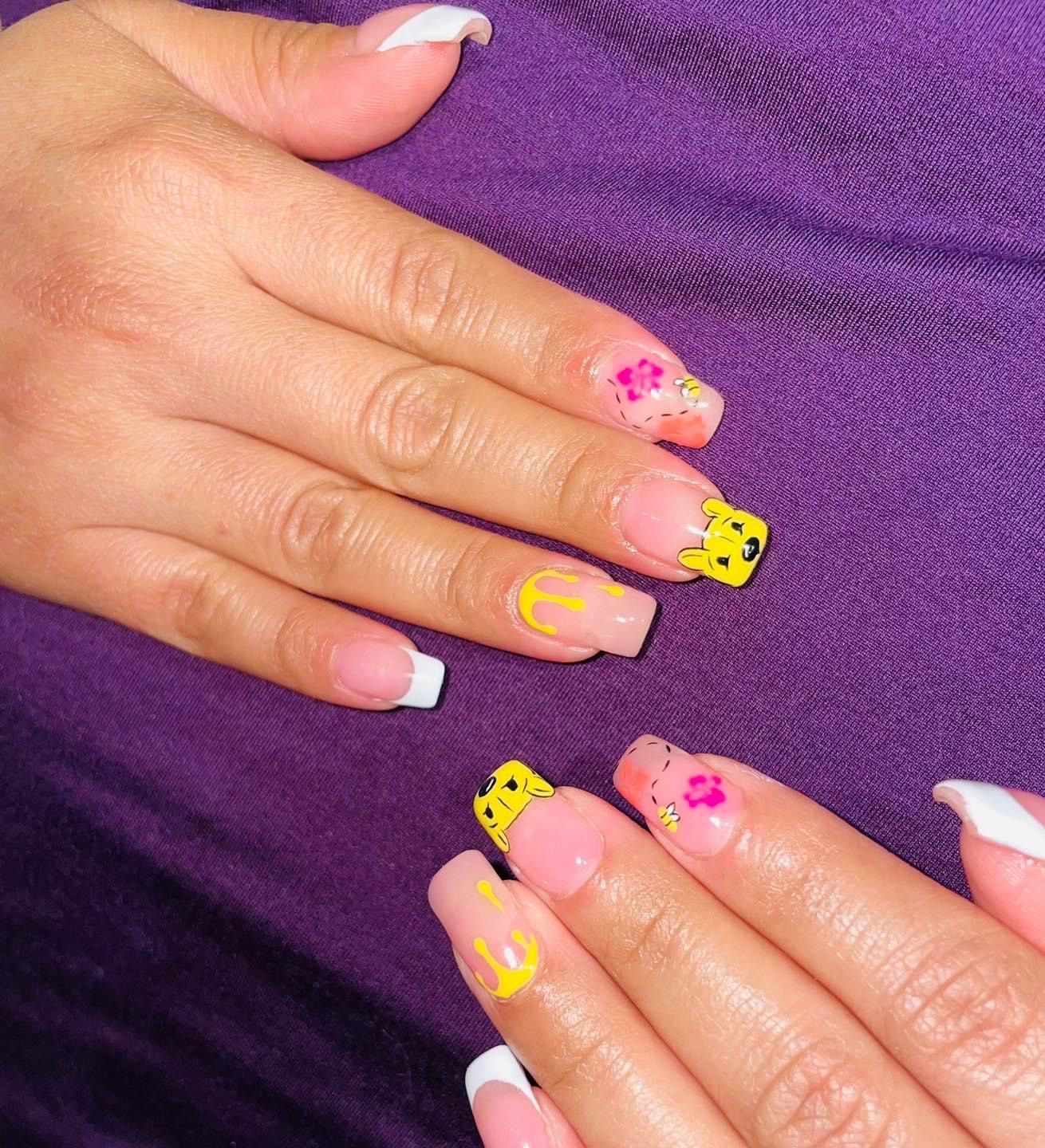 A close up of a woman 's nails with a purple background