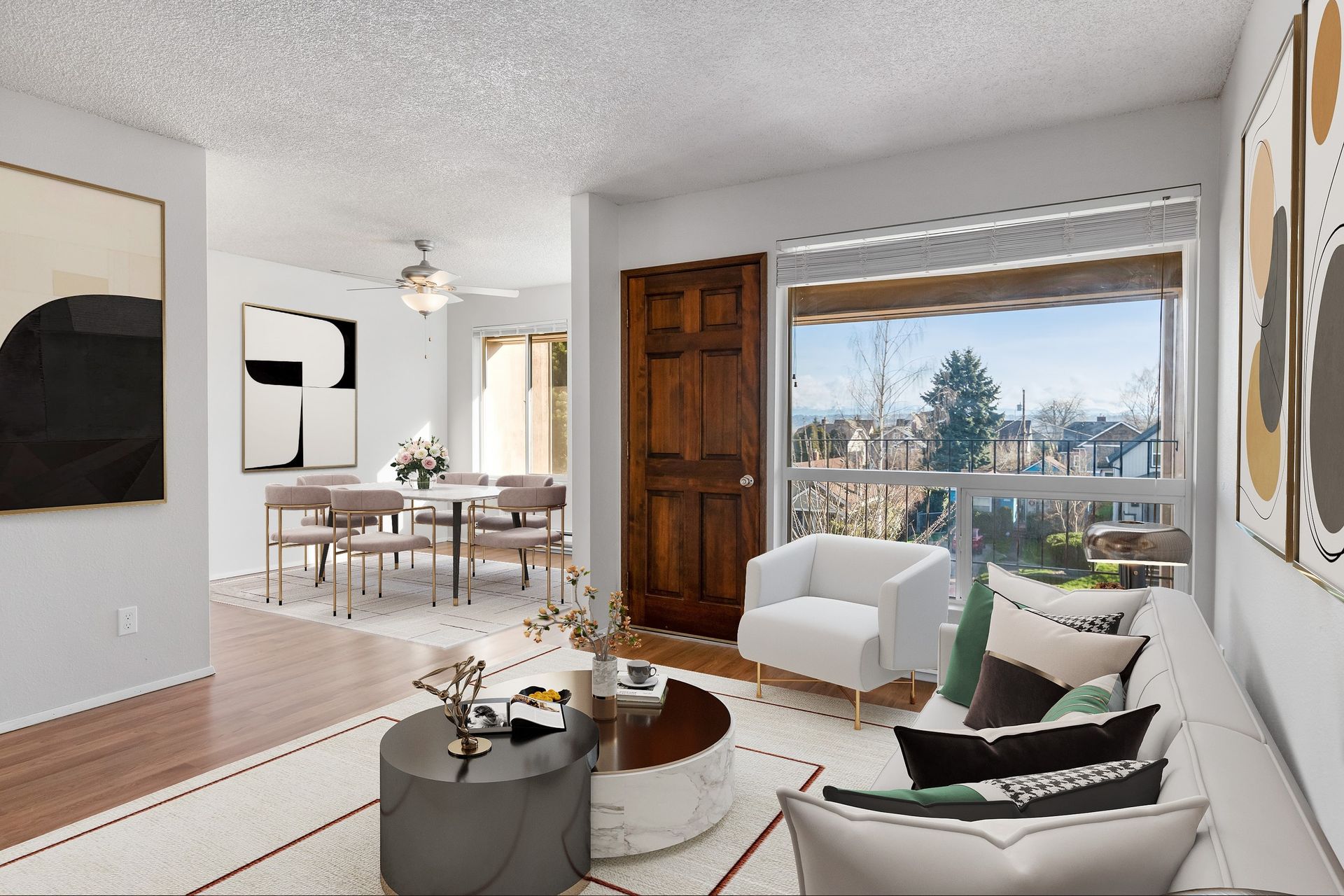 Photo showing the living room from the opposite angle, with a massive window and plenty of natural lighting