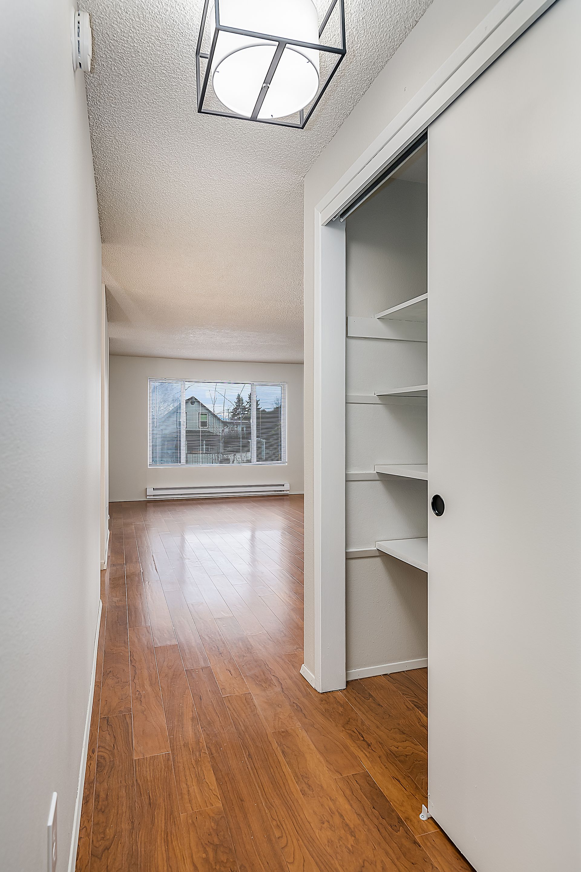 Photo showing the hallway closet open, with built-inshelving