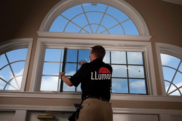 Window Tinting — Worker Tinting Windows of Residential House in Montrose, CO