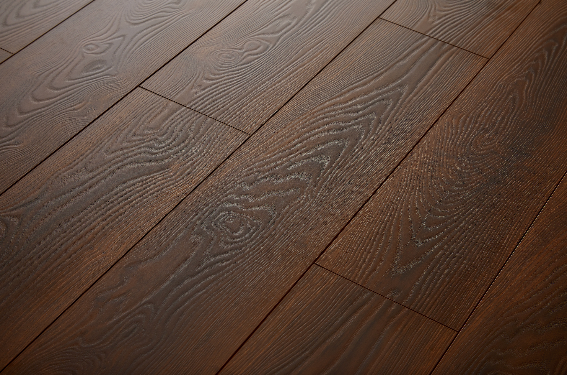 A close up of a wooden floor with a grainy texture.