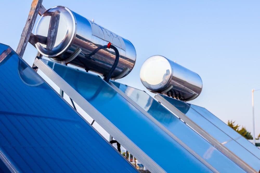 A Solar Water Heater Is Sitting On Top Of A Blue Roof — David Lewis Solahart in Ocean Shores, NSW