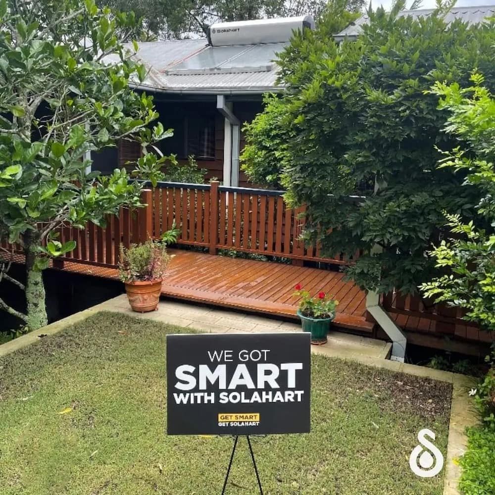 A Sign in Front of a House That Says We Got Smart With Solahart — David Lewis Solahart in Goonellabah, NSW