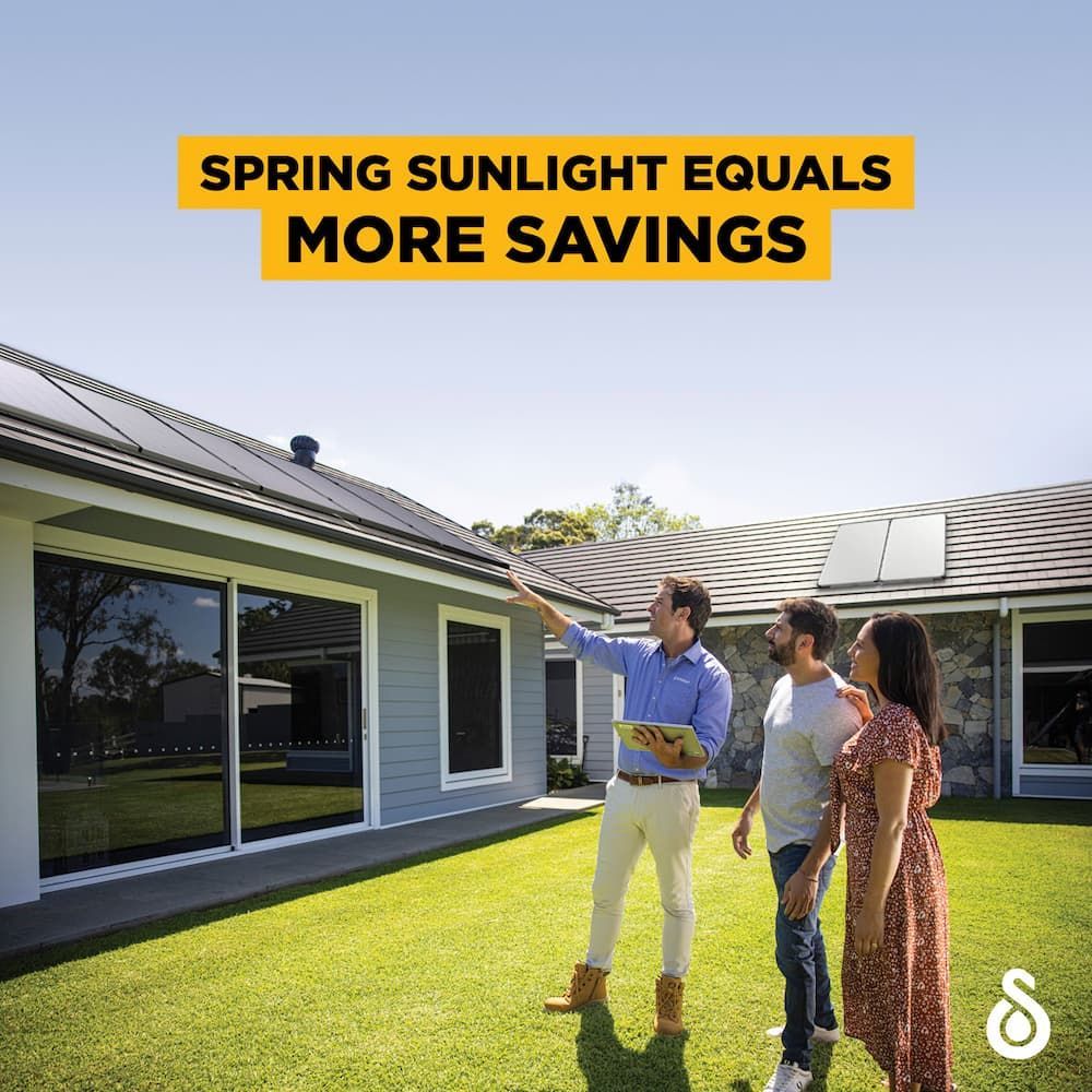 A Man And Two Women Are Standing In Front Of A House With Solar Panels On The Roof — David Lewis Solahart in Goonellabah, NSW