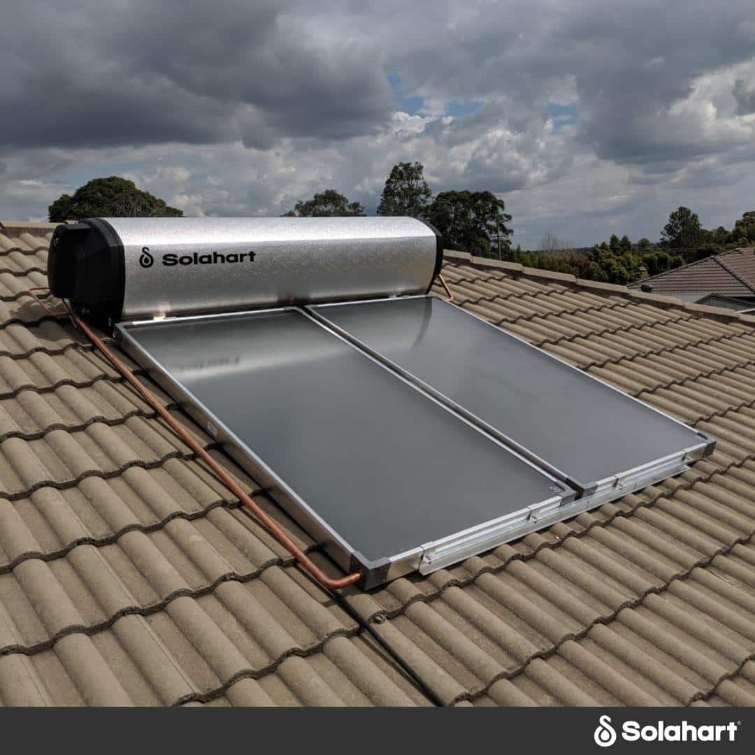 A Solahart Water Heater Is Sitting On A Tiled Roof — David Lewis Solahart in Goonellabah, NSW