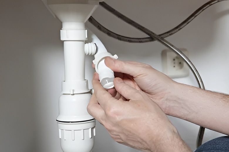 A Person's Hands Are Assembling a White Pipe Under a Sink — David Lewis Solahart in Tenterfield, NSW