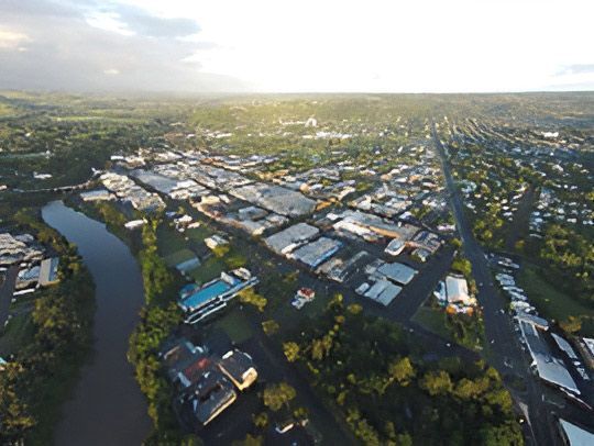 An Aerial View of a City Surrounded by Trees and a River — David Lewis Solahart in Lismore, NSW