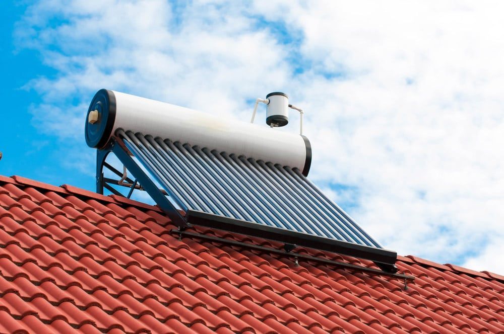 A Solar Water Heater Is Sitting On Top Of Red Tiled Roof — David Lewis Solahart in Goonellabah, NSW