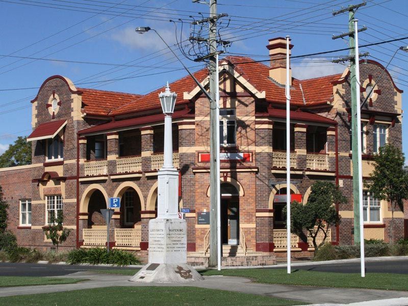 A Brick Building With A Red Roof And A White Lamp Post In Front Of It — David Lewis Solahart in Casino, NSW