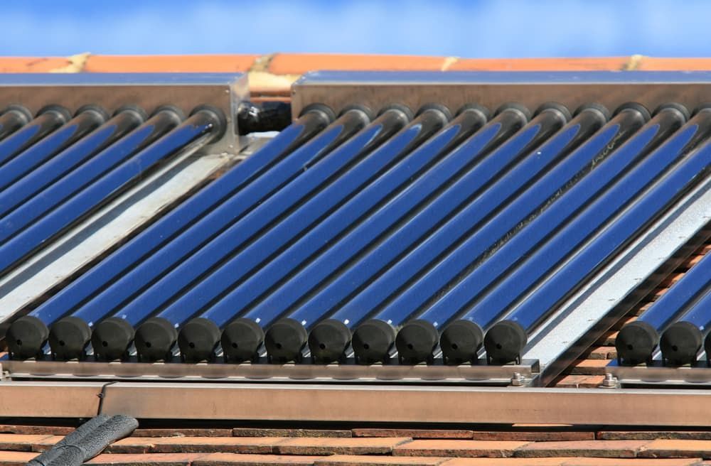 A Row Of Solar Panels On A Roof With A Blue Sky In The Background — David Lewis Solahart in Ocean Shores, NSW