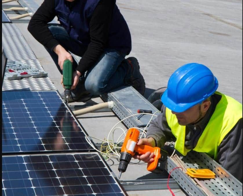 Two Men Installing Solar Panel — David Lewis Solahart in Goonellabah, NSW