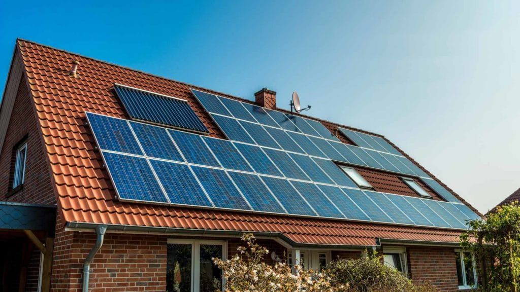 Solar Panels Installed on the Red-tiled Roof of a Brick House — David Lewis Solahart in Goonellabah, NSW