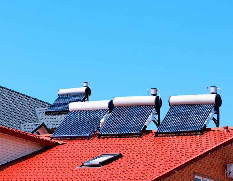 There Are Three Solar Panels On The Roof Of A House — Solahart In Goonellabah, NSW