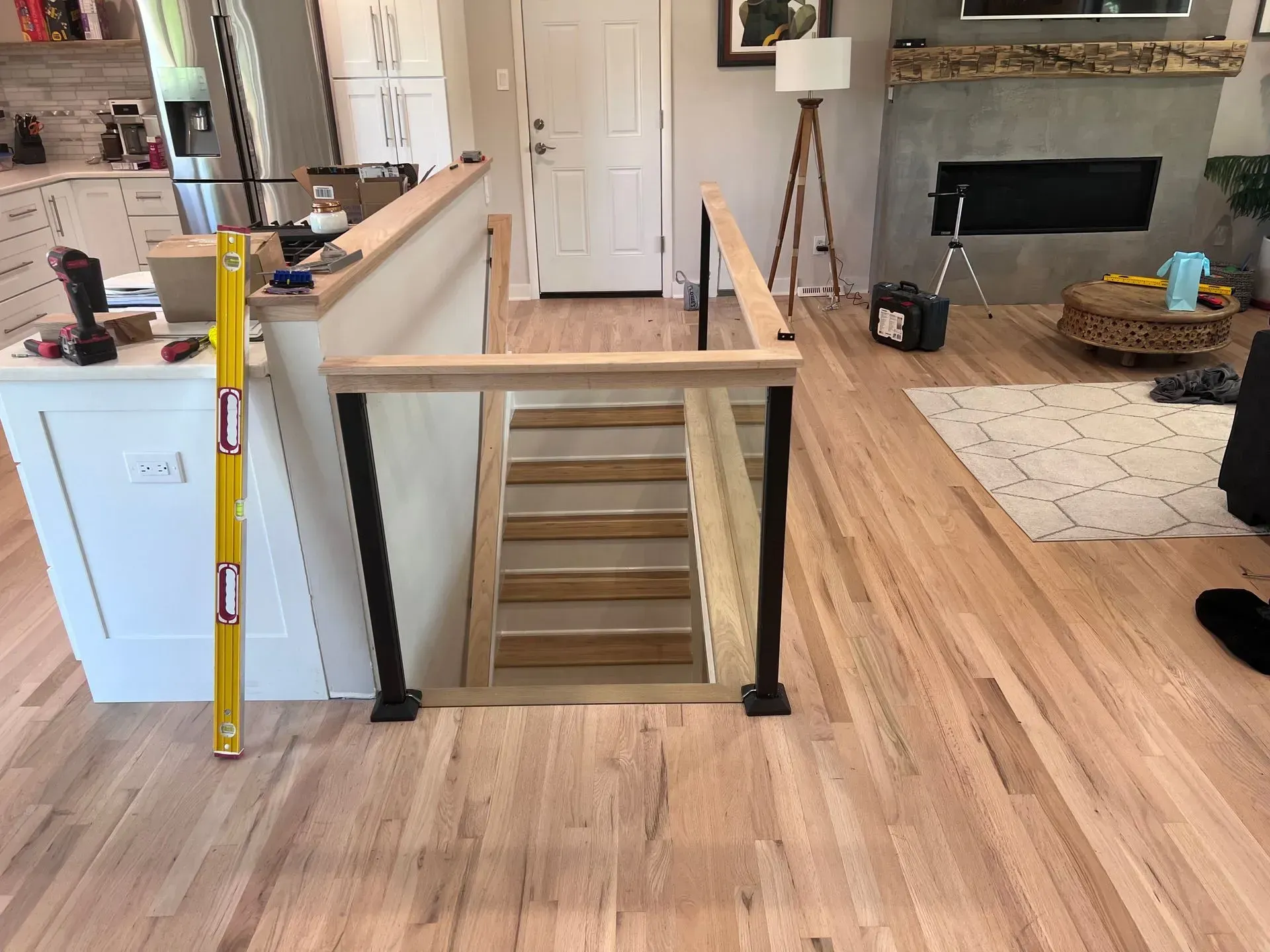 A wooden staircase is being built in a living room.