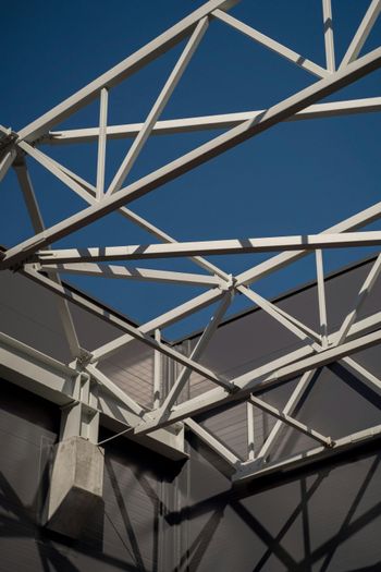 Looking up at the roof of a building with a blue sky in the background