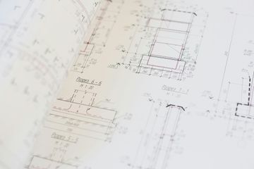 A close up of a drawing of a building on a table.