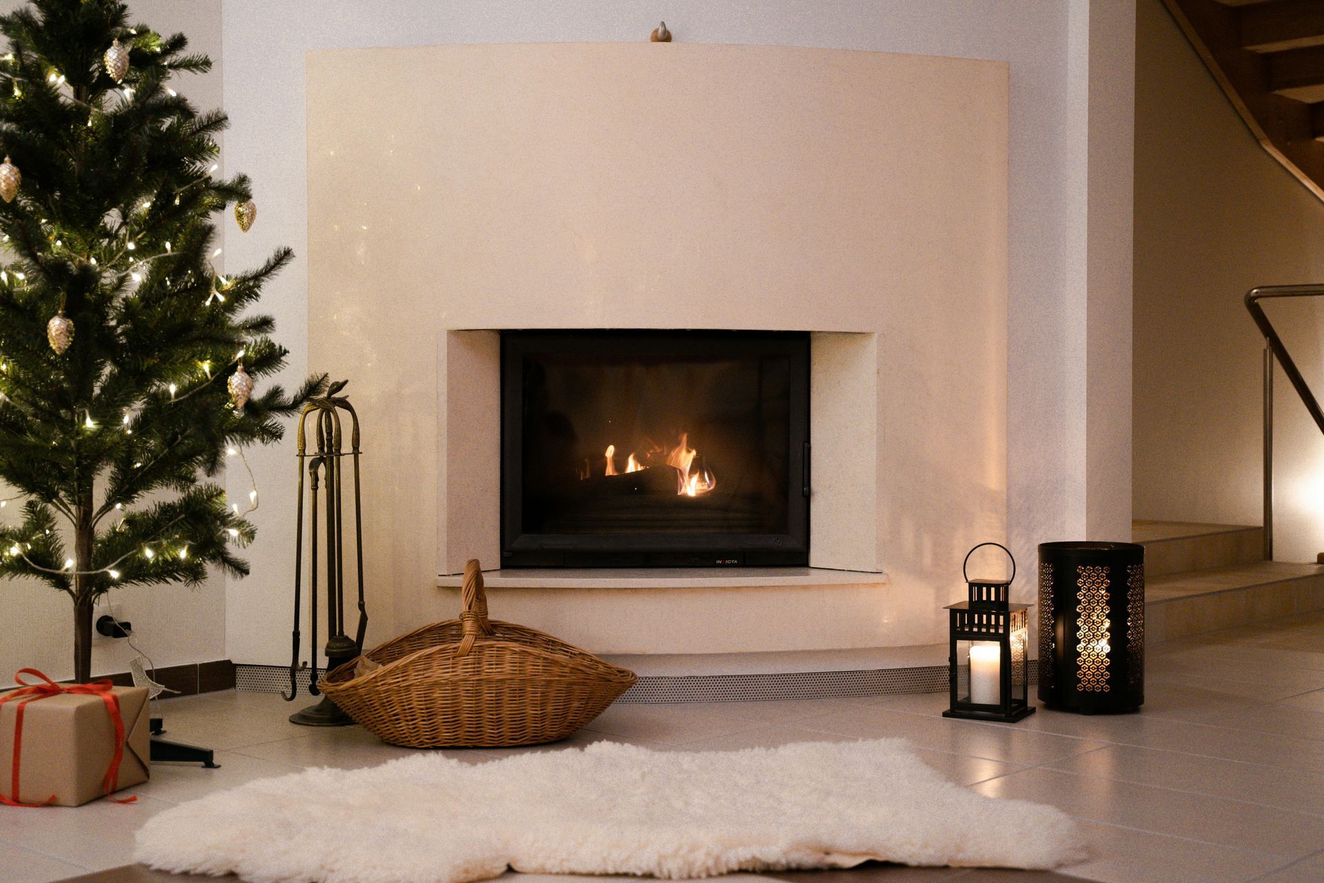 A living room with a fireplace and a christmas tree