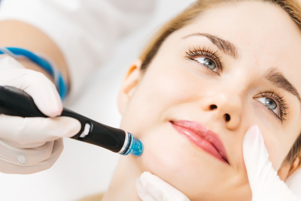 A woman is getting a facial treatment at a beauty salon.