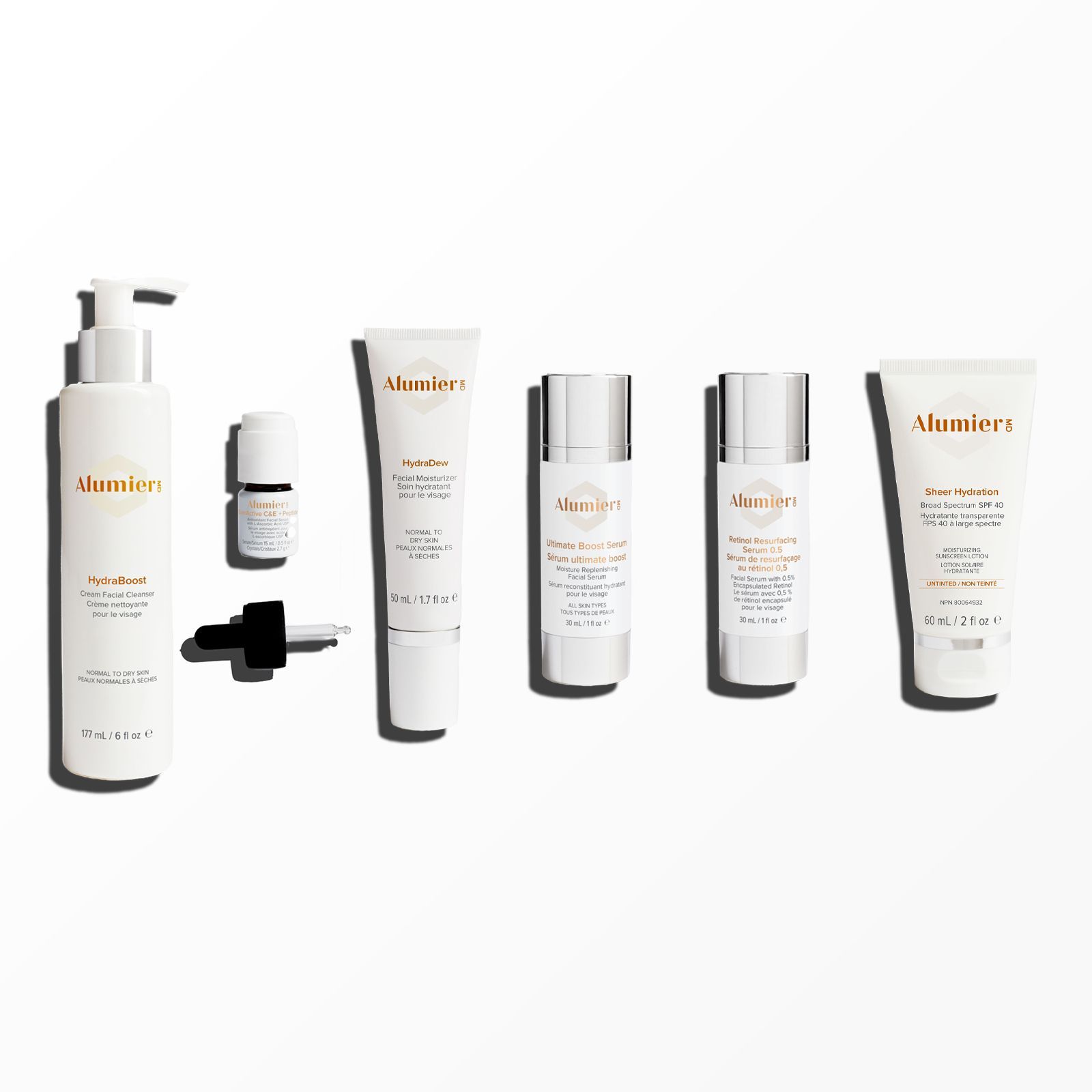 A collection of six AlumierMD skincare products, including bottles, a serum, and tubes, arranged on a plain white background.